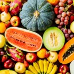 Assorted and mixed fruits on wooden background with copy space - Healthy food concept
